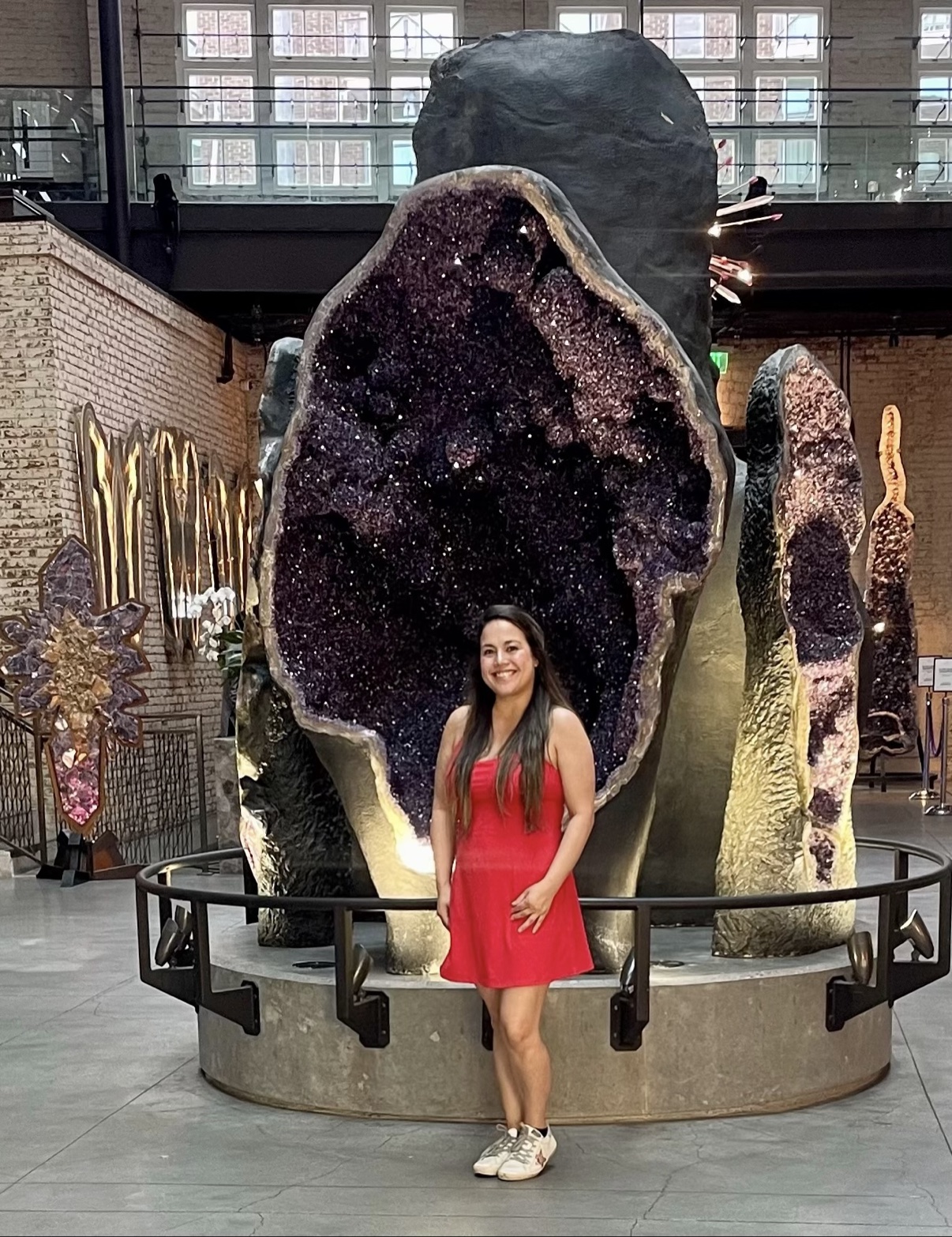 Fatima in a red dress at a museum geode exhibit